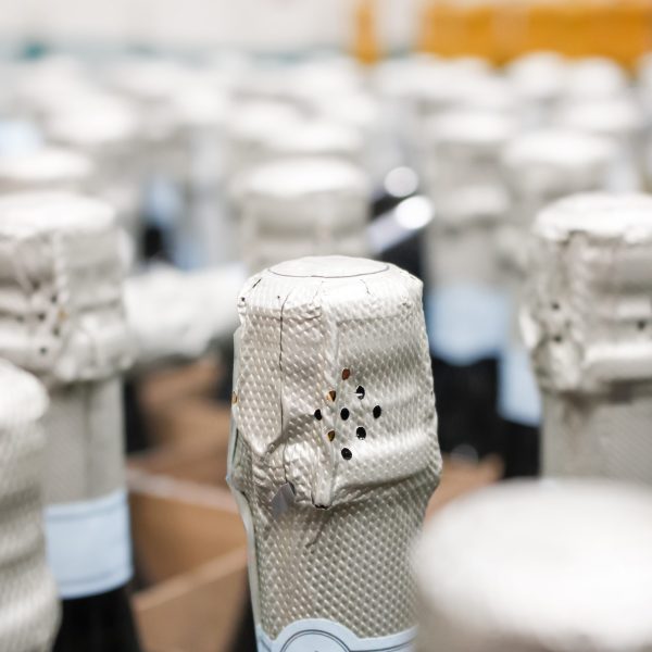 stock-photo-a-view-of-a-spread-of-foiled-wrapped-sparkling-wine-bottles-in-a-warehouse-setting-1970558849 stock-photo-a-view-of-a-spread-of-foiled-wrapped-sparkling-wine-bottles-in-a-warehouse-setting-1970558849
